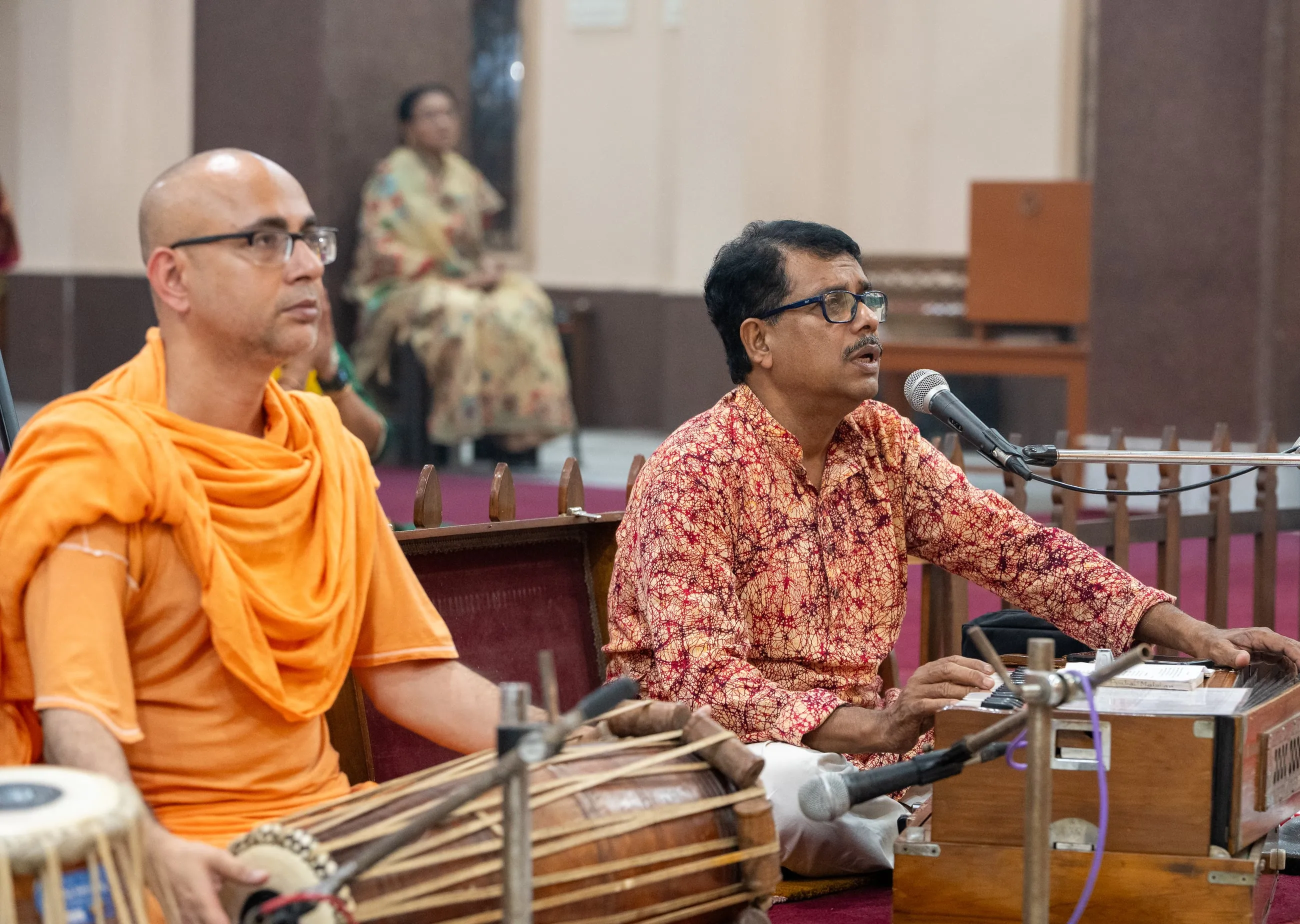 Bhajan sung at the evening arati, khol and harmonium