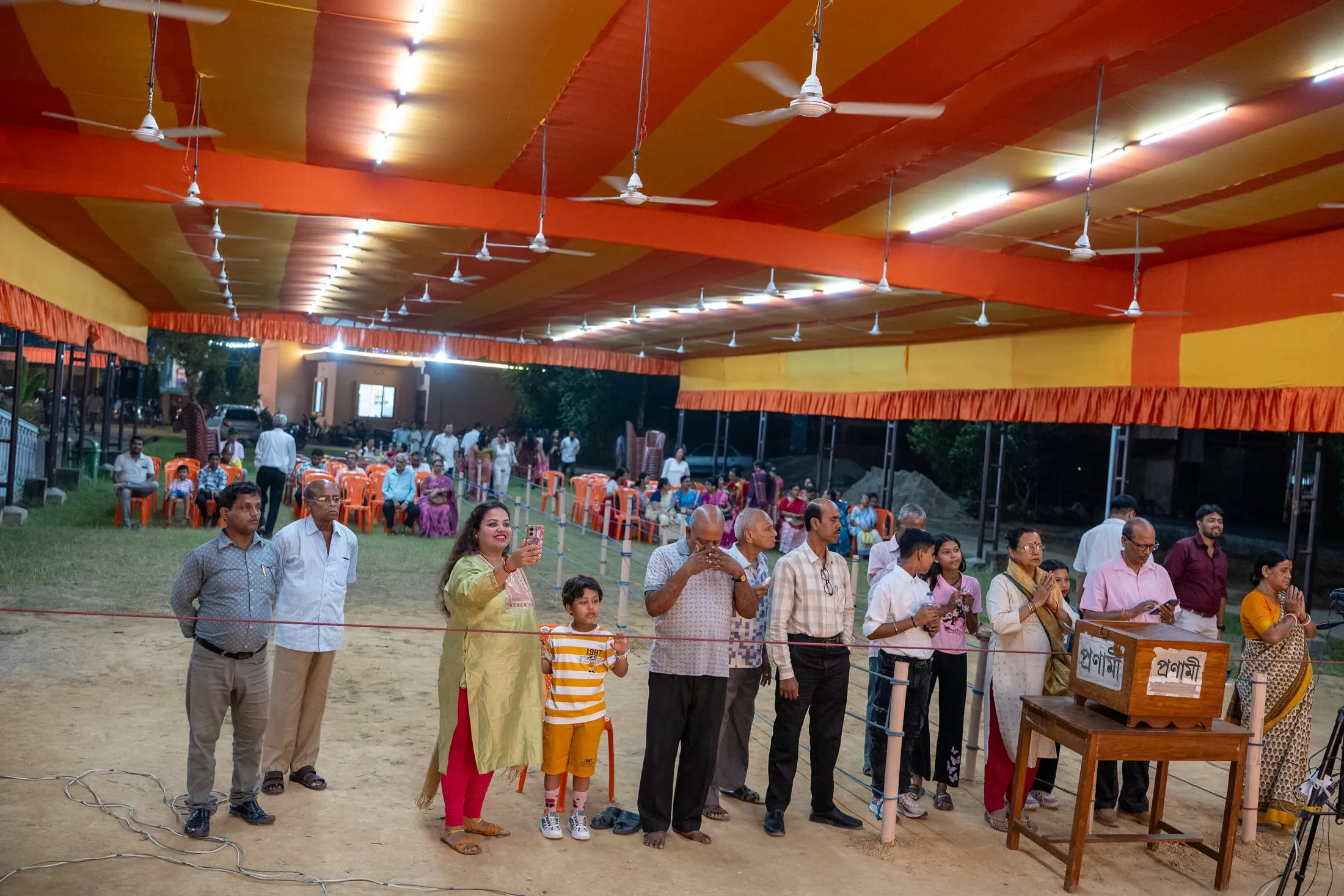 Devotees at the Durga Puja mandap in the evening