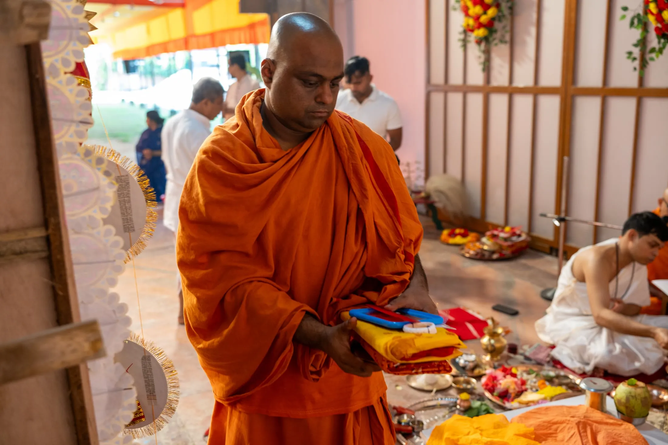 A monk carrying offerings during Durga Puja