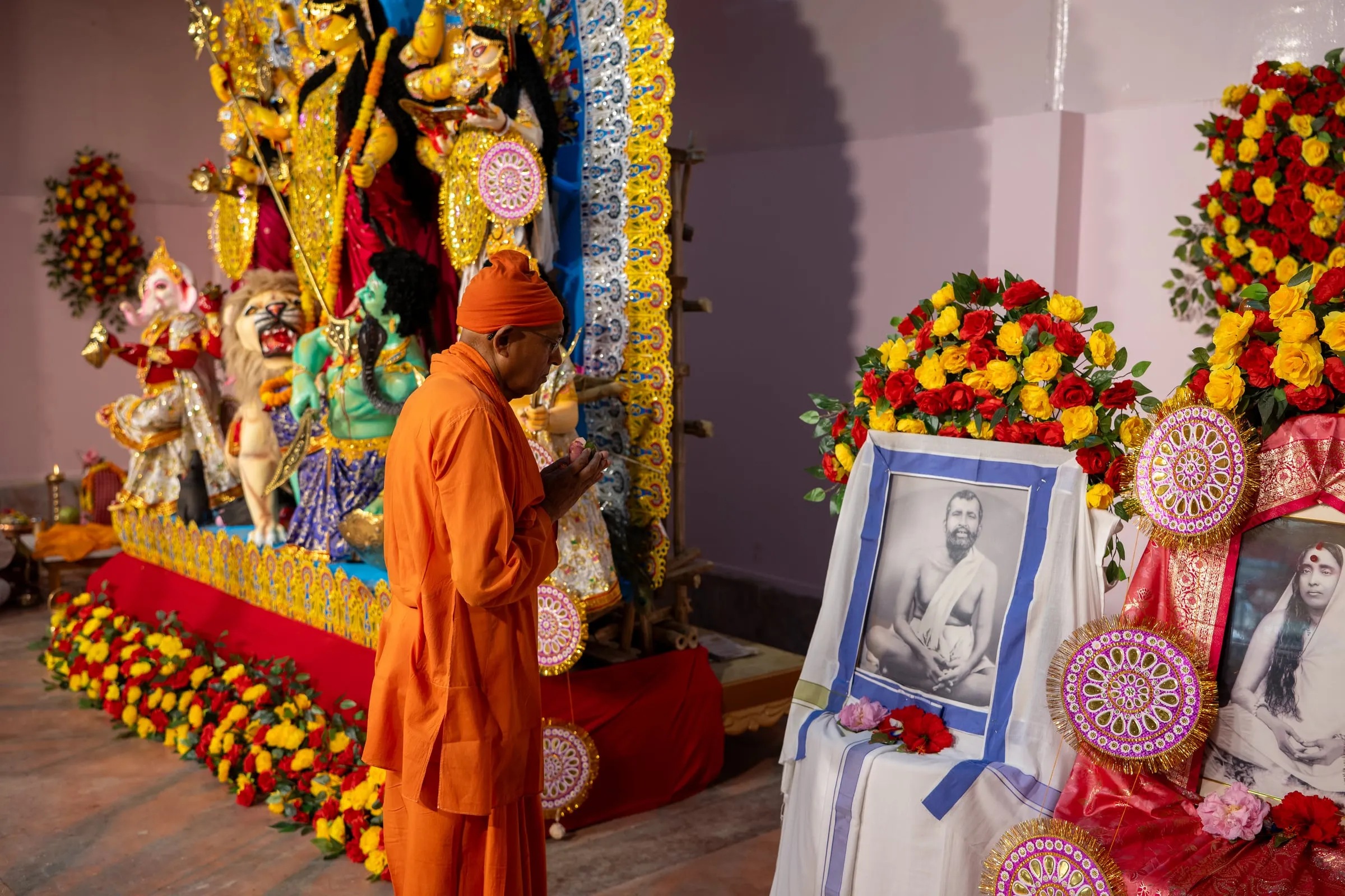 A monk at pranam before the Durga pratima