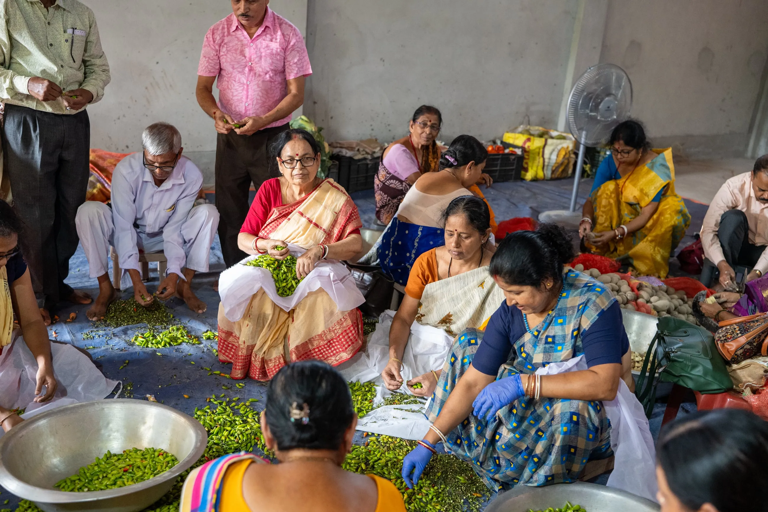 Volunteers cutting vegetables for the Mahaprasad during Durga Puja
