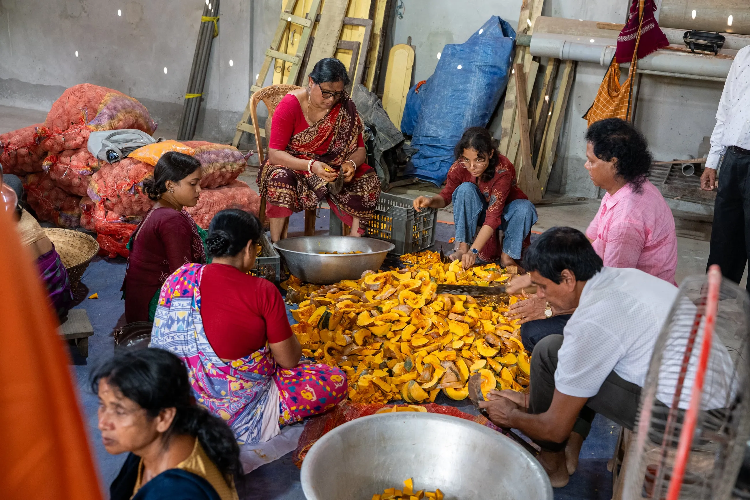 Volunteers cutting pumpkin for the Mahaprasad during Durga Puja