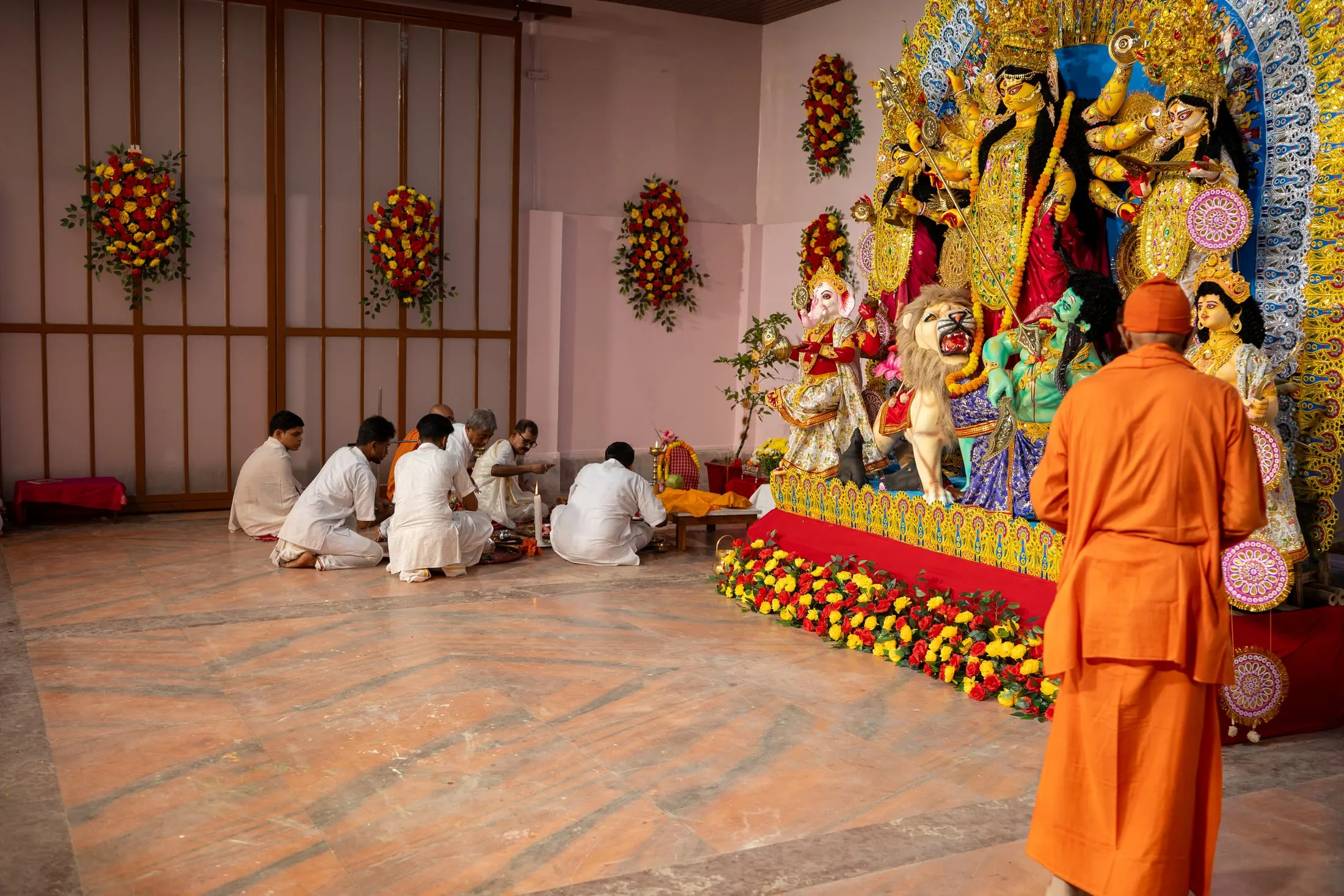 Priests at the Durga Puja ritual before the pratima
